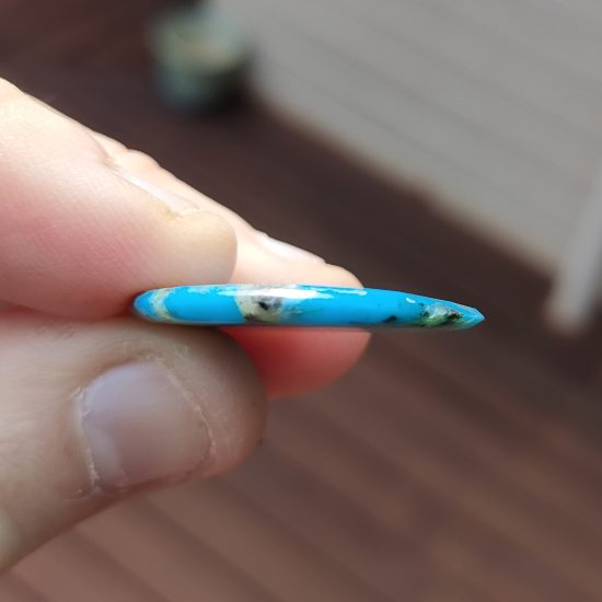 side profile of turquoise slab earring to show thickness